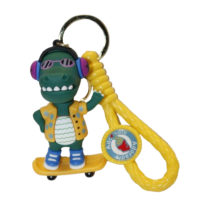 BRELOK DINOZAUR W SŁUCHAWKACH Z GITARĄ Z DESKOROLKĄ 8CM GUMOWY E1946 EMAJ